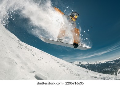 Professional snowboarder jump at off-piste ski slope. Extreme sports concept - Powered by Shutterstock