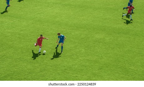 Professional Soccer Football Match Championship: Red Team Attacks, Plays in Pass. Major League Cup World Tournament. Live Sport Broadcast Channel Television Concept. High Angle Shot.