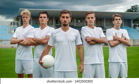 Professional Soccer Players Team Posing For A Group Photo Standing On A Football Field.