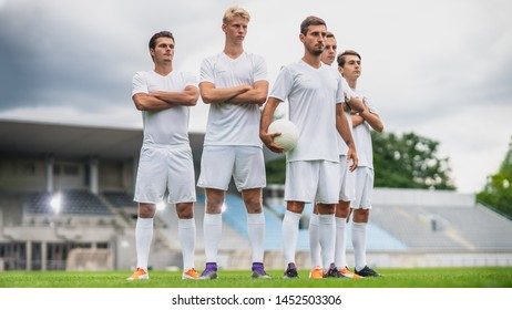 Professional Soccer Players Team Posing for a Group Photo Standing on a Football Field. - Powered by Shutterstock