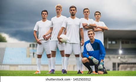 Professional Soccer Players Team Posing for a Group Photo Standing on a Football Field, Goalkeeper Sitting and Smiling. - Powered by Shutterstock