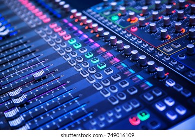 Professional sound and audio mixer control panel with buttons and sliders