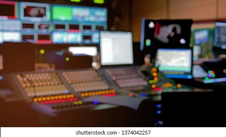 Professional Sound Engineer's Console. Television Broadcast, Working With Video And Audio Mixer, Control Broadcast In Recording Studio. Blurred Background, Monitors.