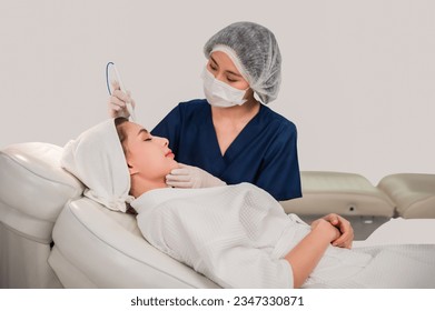 Professional specialist cosmetologist making mesotherapy with treatment facial skin care for fresh clean in beauty clinic. Beautiful Asian young woman with aesthetic face healthcare in a spa salon. - Powered by Shutterstock