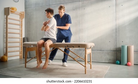 Professional Sport Physiotherapist Working On Specific Muscle Groups And Back Pain With Young Male Athlete. Sportsman Recovering From Mild Injury. Trauma Prevention Therapy, Rehabilitation.