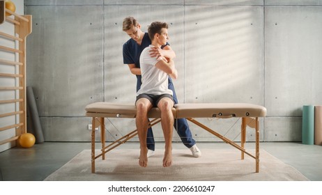 Professional Sport Physiotherapist Working on Specific Muscle Groups and Back Pain with Young Male Athlete. Sportsman Recovering from Mild Injury. Trauma Prevention Therapy or Rehabilitation.