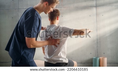 Professional Sport Physiotherapist Working on Specific Muscle Groups and Back Pain with Young and Fit Male Athlete. Sportsman Recovering from Mild Injury. Trauma Prevention Therapy or Rehabilitation.