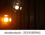 Professional spotlights against curtain in darkness. Space for text