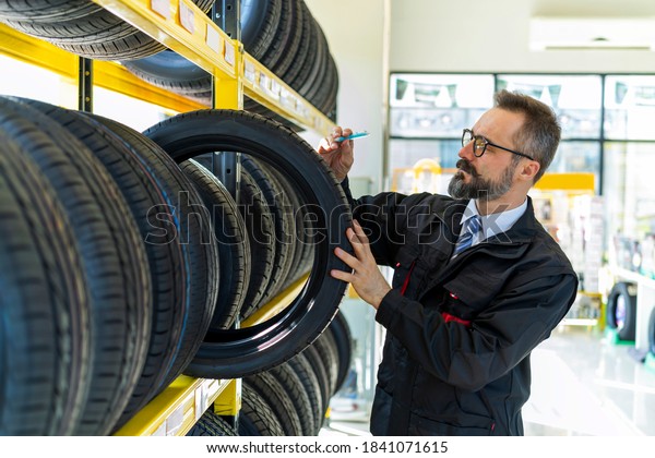 Professional staff working on tires\
inspection in the auto services/tires services\
center