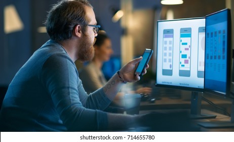 Professional Statistician Works with Graphics on His Personal Computer. In the Background His Colleagues Working. - Shutterstock ID 714655780