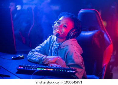 Professional Streamer African Young Woman Cyber Gamer In Neon Color Blur Background.