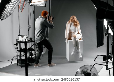 Professional studio for fashion photoshoot with model and photographer capturing stunning images - Powered by Shutterstock