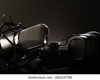 Professional Studio Microphone And Headphones. Close-up. Monochrome Image. Recording Studio, Vocals, Concert, Karaoke, Radio, Conversational Genre. There Are No People In The Photo.