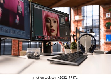 Professional studio setup for AI generated content and photography editing. Empty workspace with monitors displaying retouching software, supports creative careers in visual design.