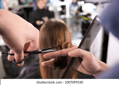 Professional Stylist Cutting Woman's Hair In Salon, Closeup