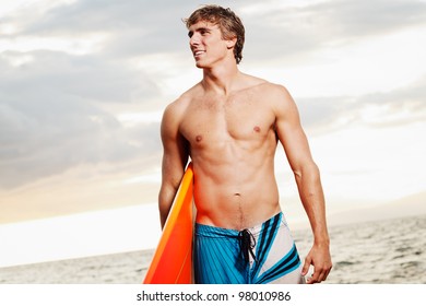 Professional Surfer Holding A Surf Board