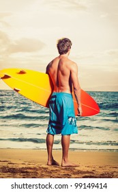 Professional Surfer Holding A Surf Board