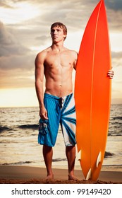 Professional Surfer Holding A Surf Board