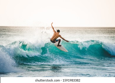 professional surfer riding waves in Dreamland Beach, Bali, Indonesia. men catching waves in ocean. Tail slide water surf, action water board sport