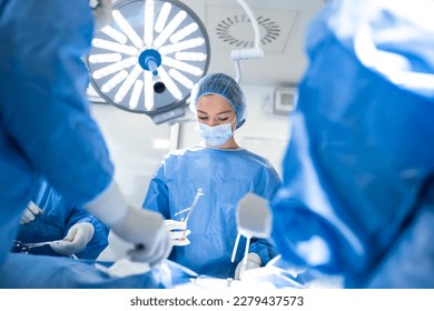 Professional surgeon holding forceps with suture thread. surgeon holding needle holder and suture material. Suture thread. Nylon surgical thread. Needle holer and suture material in operating room - Powered by Shutterstock