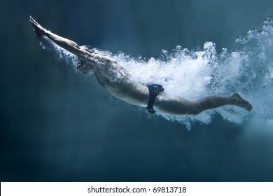 professional swimmer underwater after the jump