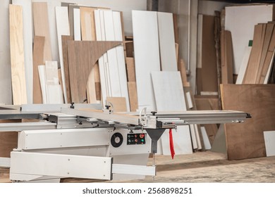 Professional Table Saw Machine. Saw Bench. Wood workshop tools studio, Wooden furniture factory workplace cutting machine tool and stock pile of plywood