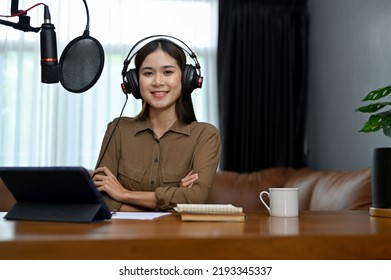 Professional And Talented Young Asian Female Blogger Podcaster In Her Home Studio, Using Recording Equipment To Running Her Online Radio Show.