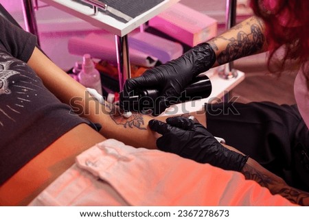 Similar – Image, Stock Photo Anonymous tattoo artist applying transfer paper on client’s back