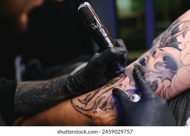 Professional tattoo artist makes a tattoo. - Powered by Shutterstock