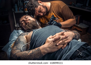 Professional Tattoo Artist Showing Process Of Making A Tattoo In Tatoo Salon.