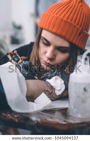 Professional tattooing process on arm piece
