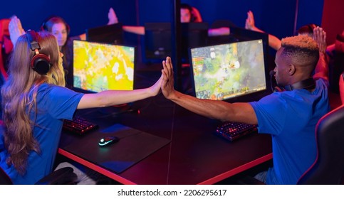 Professional Team Computer Gamer Players Play Online Video Games, Neon Color, Soft Focus, Back View.