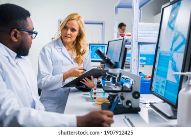 Professional team of scientists is working on a vaccine in a modern scientific research laboratory. Genetic engineer workplace. Future technology and science.