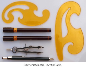 Professional Technical Drawing Tools Layout with French Curves and Precision Pens for Engineering Design   
