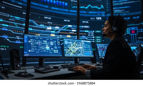Professional IT Technical Support Specialists and Software Programmer Working on Computers in Monitoring Control Room with Digital Screens with Server Data, Blockchain Network and Surveillance Maps.
