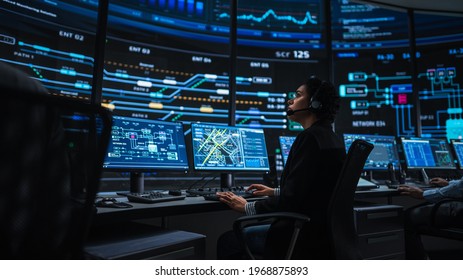 Professional IT Technical Support Specialists and Software Programmer Working on Computers in Monitoring Control Room with Digital Screens with Server Data, Blockchain Network and Surveillance Maps. - Shutterstock ID 1968875893