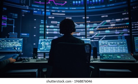 Professional IT Technical Support Specialists and Software Programmer Working on Computers in Monitoring Control Room with Digital Screens with Server Data, Blockchain Network and Surveillance Maps.