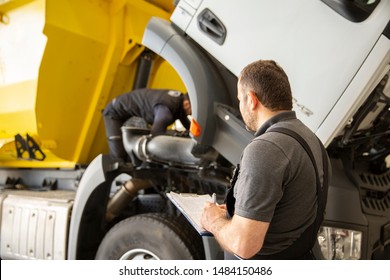 Professional Technician Checking Truck Maintenance List, Truck Service
