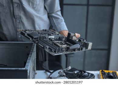 Professional technician or engineer repairing or assembling electronic computer PC equipment.