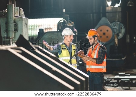 professional technician engineer with safety working in industrial manufacturing factory, checking equipment of machinery production technology construction operating, success commitment determination