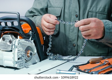 Professional Technician Looking Chain Of Chainsaw.Repair Chainsaw In Repair Service.