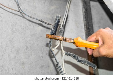 a professional technician man is holding risky electricity supply joints 