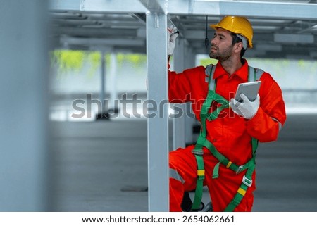 professional technician worker or engineer hold tablet during maintenance or check system under solarcell panel.