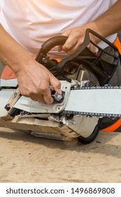 Professional Technician Working By Repair Service.Repairing Chainsaw In Repair Shop.