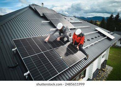 Professional technicians securing heavy solar photovoltaic panels. Male workers installing solar battery on a roof. Concept of green enegry resources. - Powered by Shutterstock