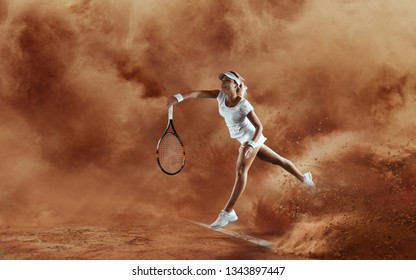 Professional tennis player. Female tennis player in action during game on sand background. - Powered by Shutterstock