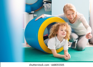 Professional therapist explaining new exercise to a little boy