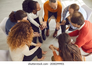 Professional Therapist Meeting With Multiracial Group Therapy Patients. Diverse People Supporting Each Other And Talking About Their Issues And Ways To Solve Problems. View From Above, High Angle Shot