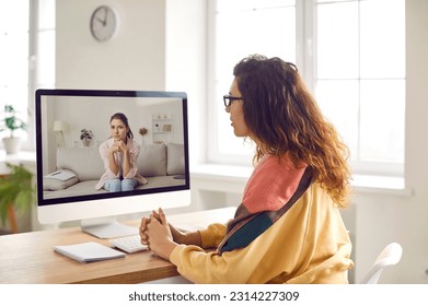 Professional therapist or psychologist gives video consultation via webcam camera conference meeting on computer and helps young woman patient understand herself. Online therapy, psychotherapy concept