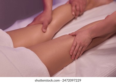 Professional therapists provide a soothing and relaxing leg massage therapy session to enhance well-being. - Powered by Shutterstock